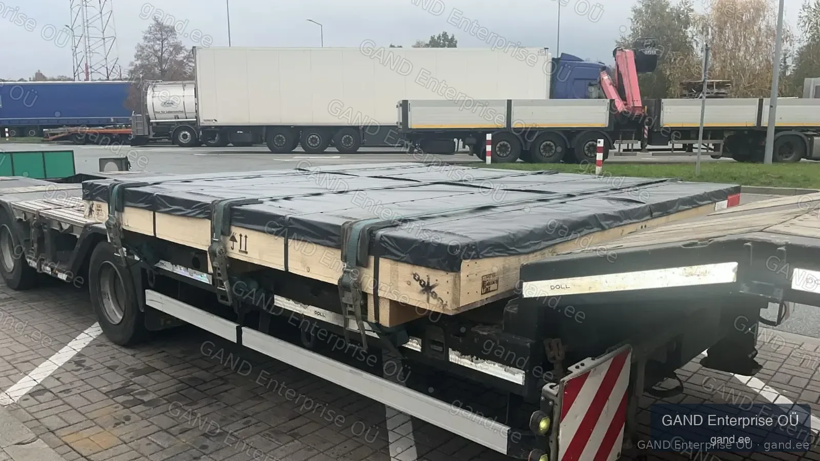 Oversized vessel engine component secured on flatbed for transport